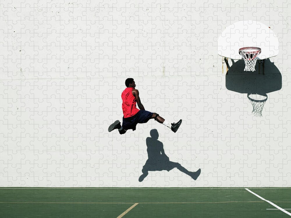 Shadow Jigsaw Puzzle featuring the photograph Teenage Boy 16-18 Dunking Basketball On by Thomas Barwick