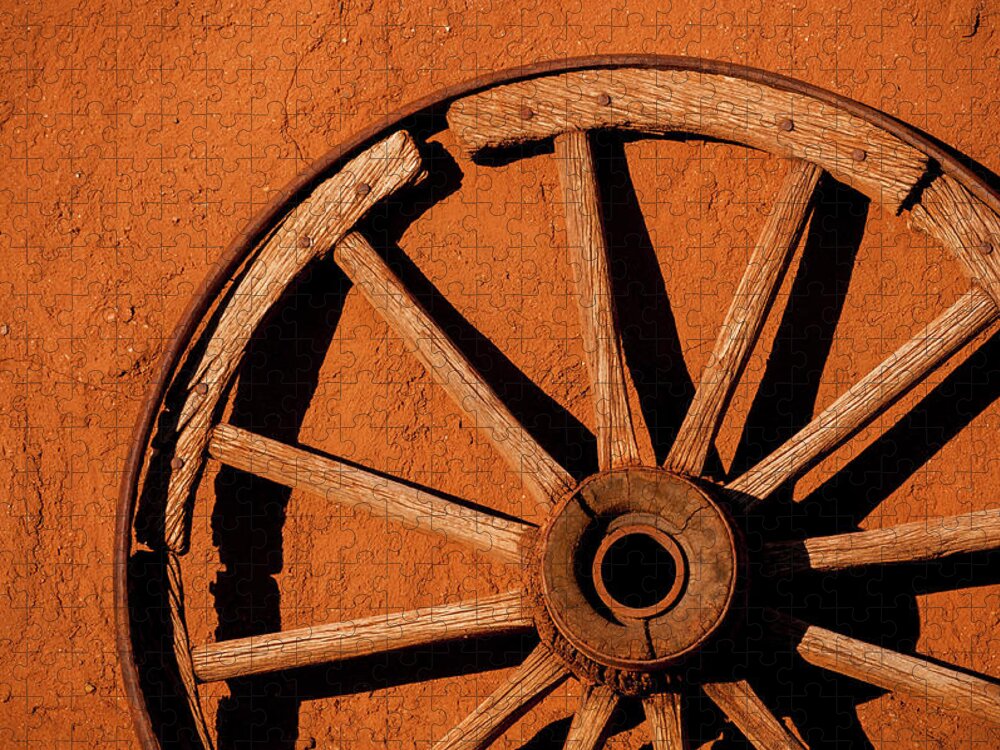Shadow Jigsaw Puzzle featuring the photograph Weathered Wagon Wheel Against An Adobe by Photo By Sam Scholes