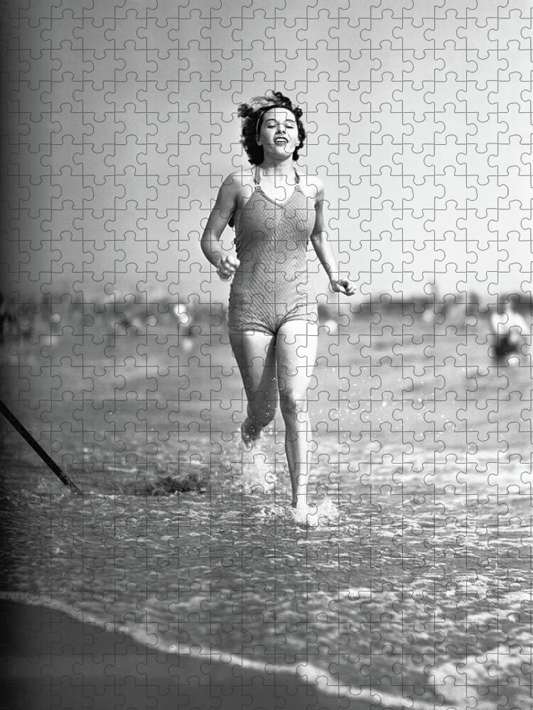 1950-1959 Jigsaw Puzzle featuring the photograph Woman In Swimsuit Running On Shoreline by George Marks