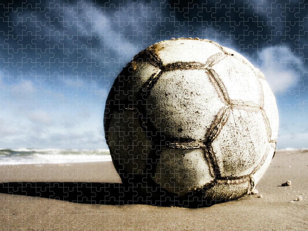 Shadow Puzzle featuring the photograph Worn And Old Soccer Ball On Sand by Vithib