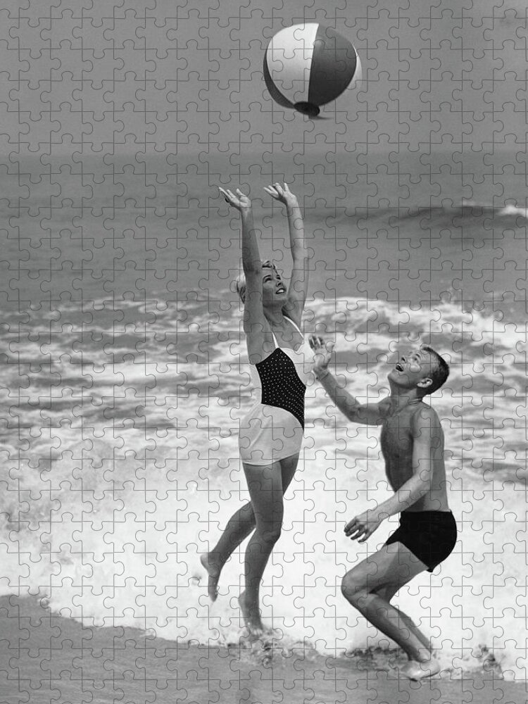 Young Men Jigsaw Puzzle featuring the photograph Young Couple Playing With Beach Ball At by Stockbyte