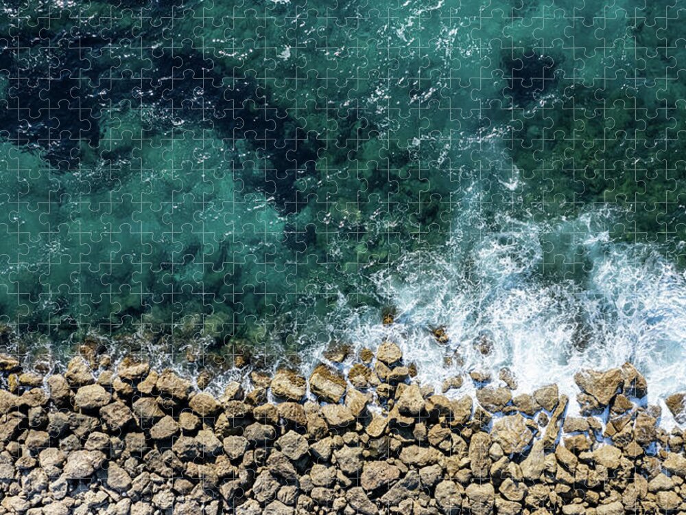 Seascape Jigsaw Puzzle featuring the photograph Aerial view from flying drone of crystal blue ocean water and sea wall. by Michalakis Ppalis