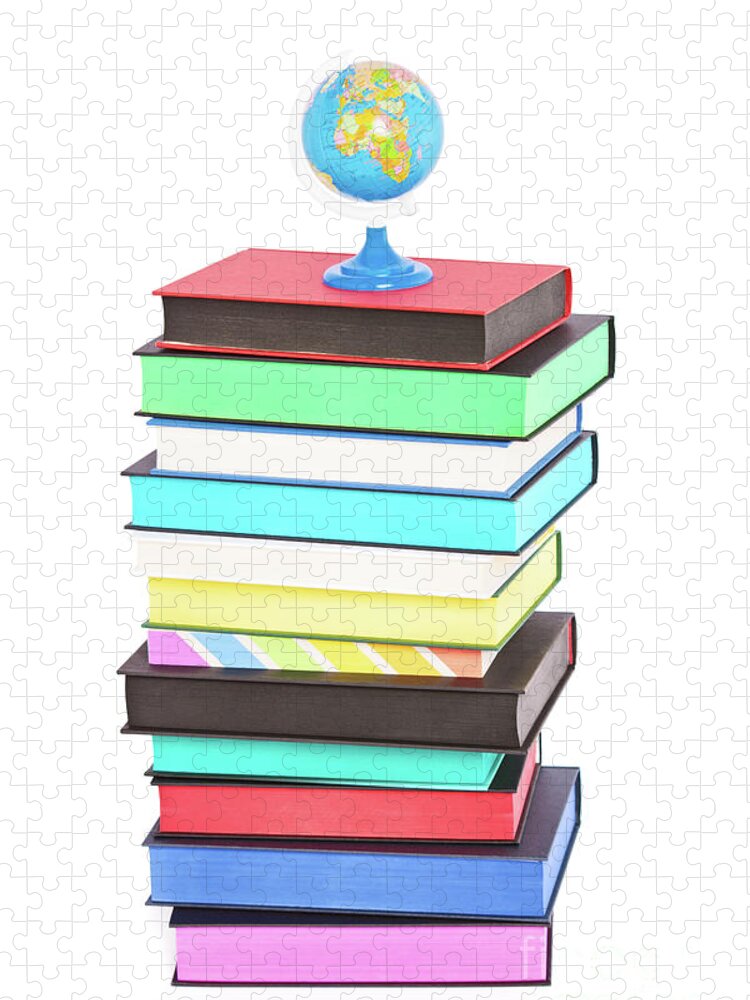 Books Jigsaw Puzzle featuring the photograph A globe on top of stack of colorful books by Mendelex Photography