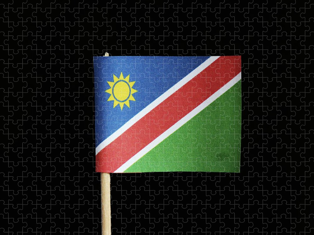 Stå sammen ledsage indstudering A national flag of Namibia on toothpick on black background. A consists of  a white-edged red diagonal band radiating from the lower hoist side corner.  The upper is blue with yellow sun