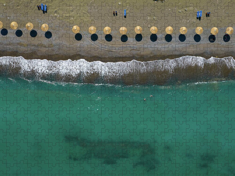  Beach Jigsaw Puzzle featuring the photograph Aerial view from a flying drone of beach umbrellas in a row on a by Michalakis Ppalis