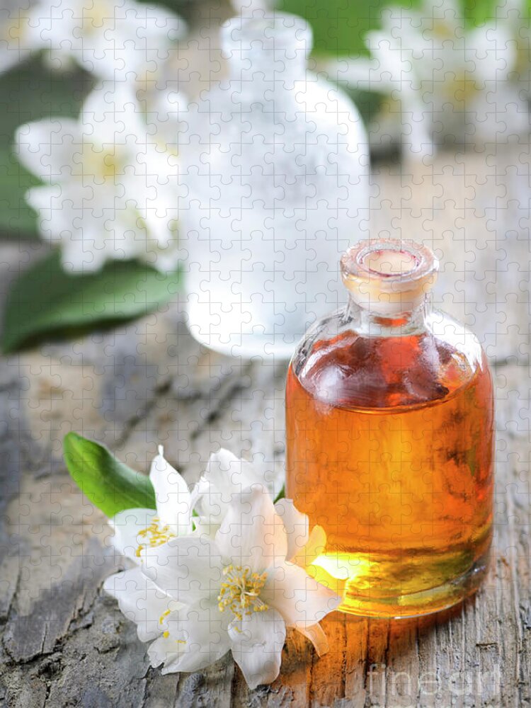 Essential Jigsaw Puzzle featuring the photograph Homemade Essential oil and fresh jasmine flower by Jelena Jovanovic