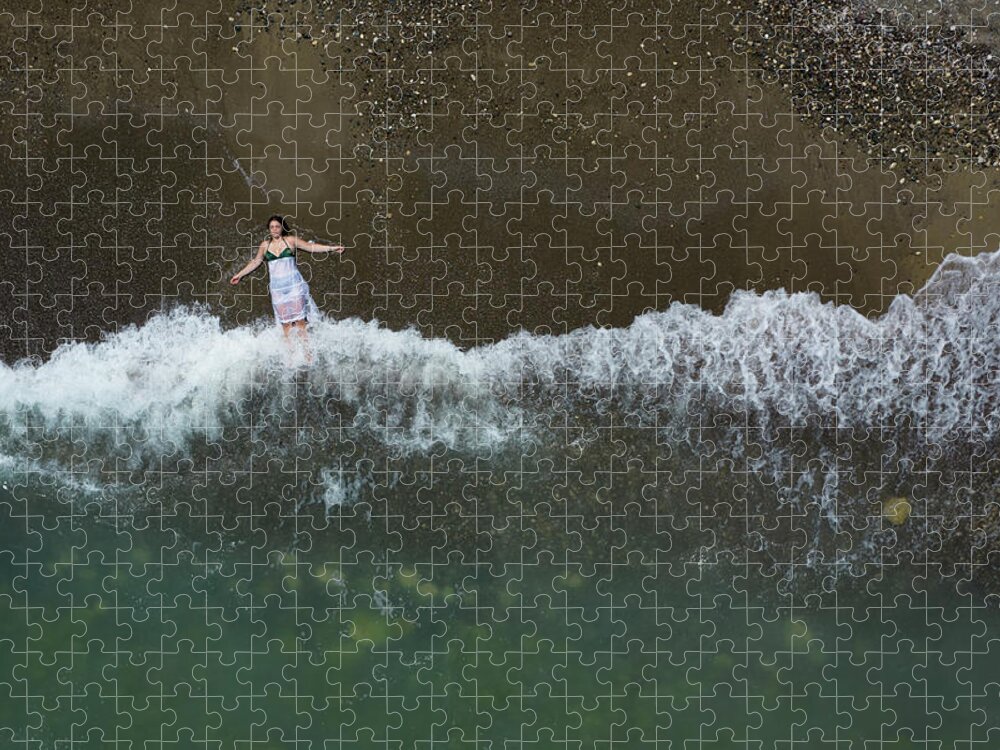 Holidays Jigsaw Puzzle featuring the photograph Woman with white dress resting on a sandy beach with braking waves on the shore. Overhead shot. Aerial drone photograph by Michalakis Ppalis