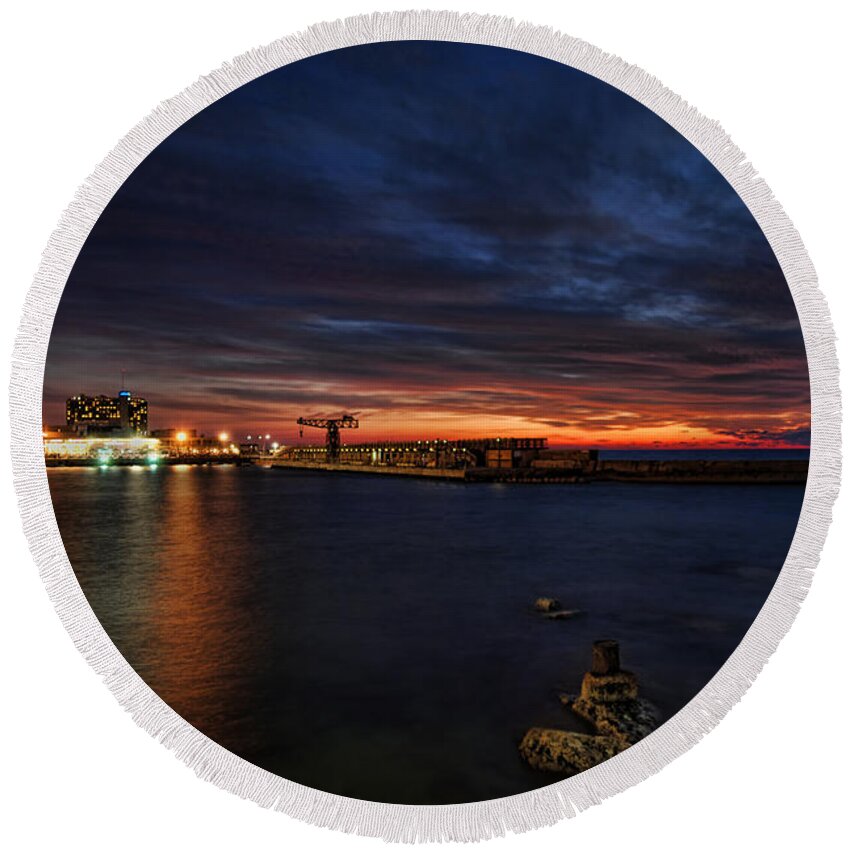 Israel Round Beach Towel featuring the photograph a flaming sunset at Tel Aviv port by Ron Shoshani