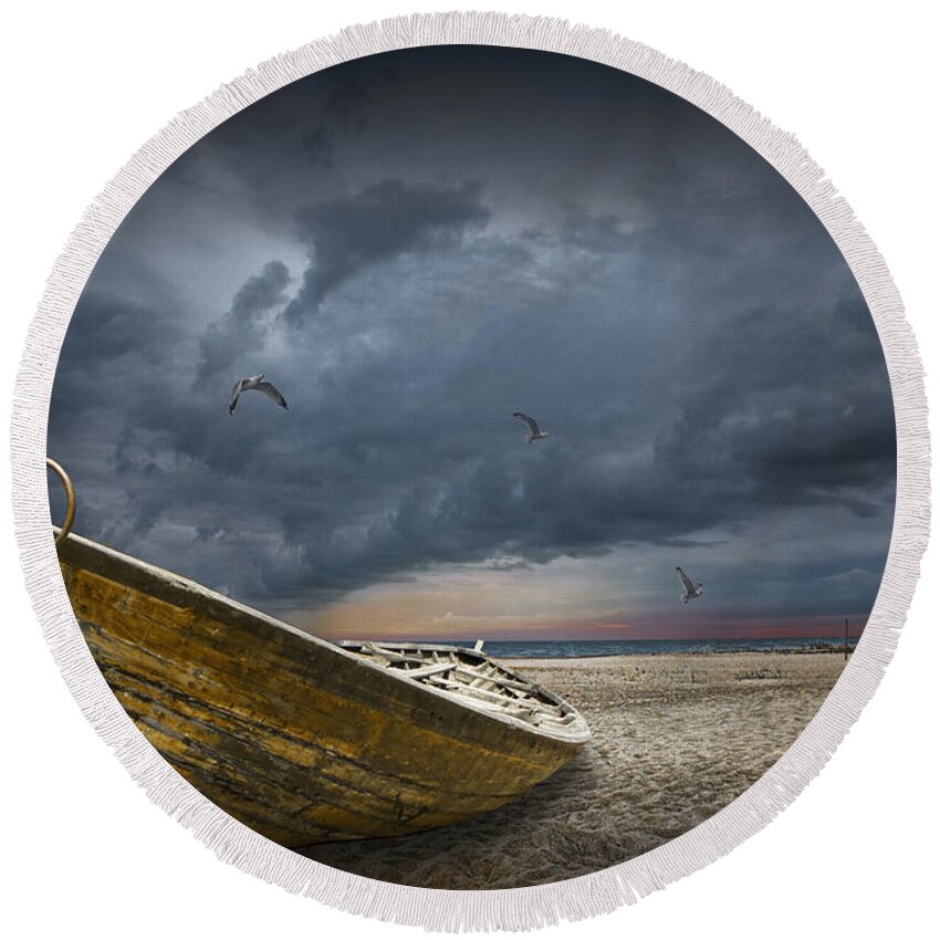 Art Round Beach Towel featuring the photograph Boat with gulls on the beach with oncoming storm by Randall Nyhof