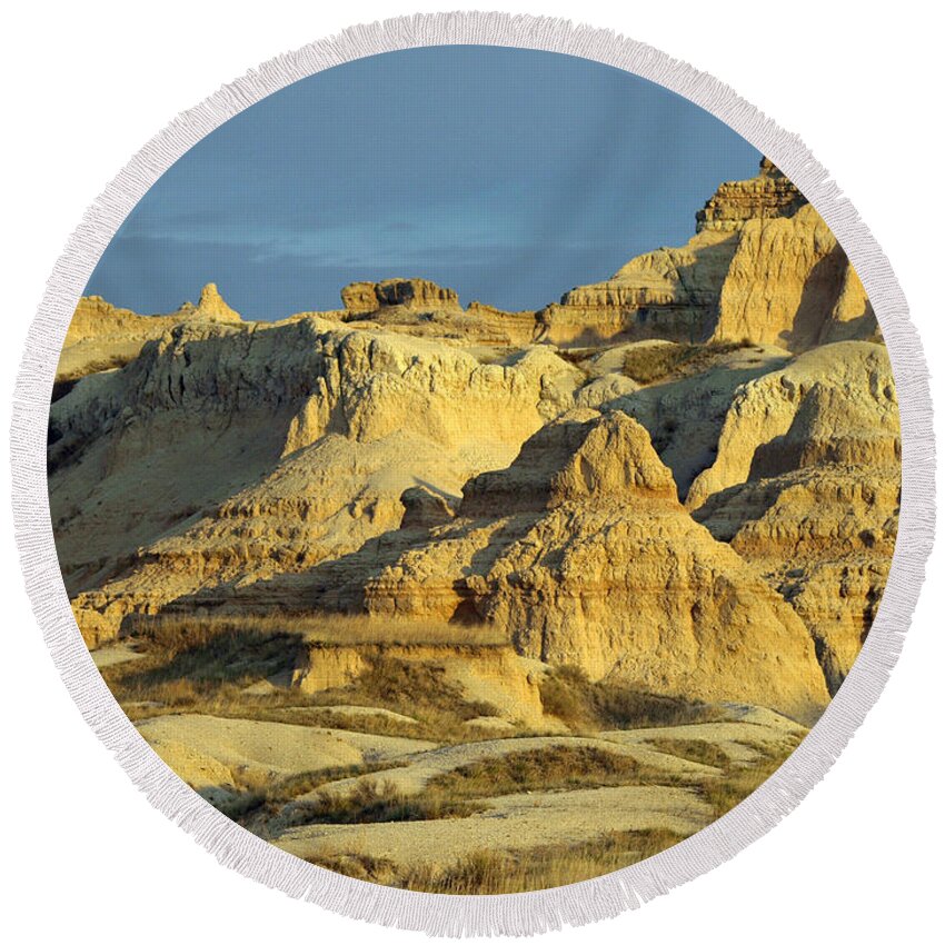 Badlands National Park South Dakota Sd Parks North America American Badland Landscape Landscapes Sandstone Sandy Formations Formation Bad Lands Sky Skies Dusk Neutral Beige Colors Rugged Beauty Scenic Scenery Hiking Travel Vacation Destinations Blue Rapid City Brown Lighting Light Dimensional Dimensions Photography Photos Artistic Art Unique Rocky Rock Rocks James Melissa Peterson Nature Outdoor Wilderness Adventure Wall Buttes Pinnacles Grass Prairie Southwestern Dynamic Golden Hour Unusual Round Beach Towel featuring the photograph Dynamic Lighting by James Peterson