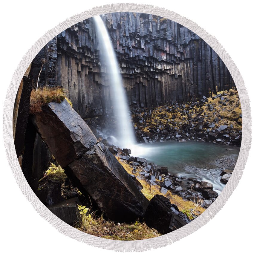 Waterfall Round Beach Towel featuring the photograph Flowing through basalt rocks II by Matteo Colombo