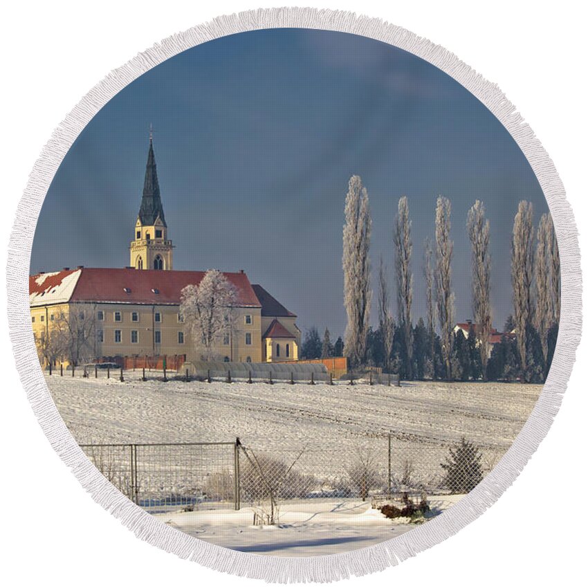 Krizevci Round Beach Towel featuring the photograph Greek catholic cathedral in snow landscape by Brch Photography