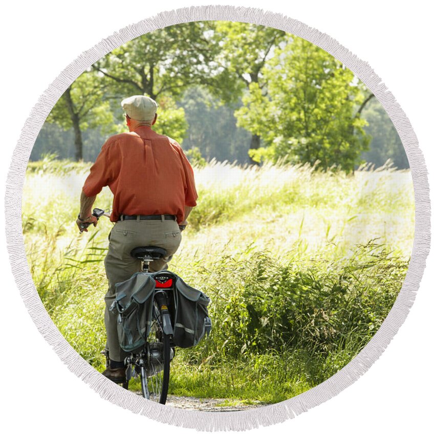 Old Round Beach Towel featuring the photograph Old man on a bike by Patricia Hofmeester