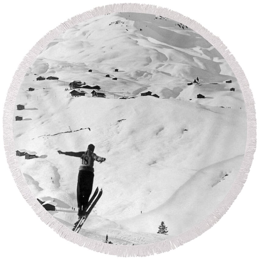 1937 Round Beach Towel featuring the photograph Skier Leaping Over A Valley by Underwood Archives