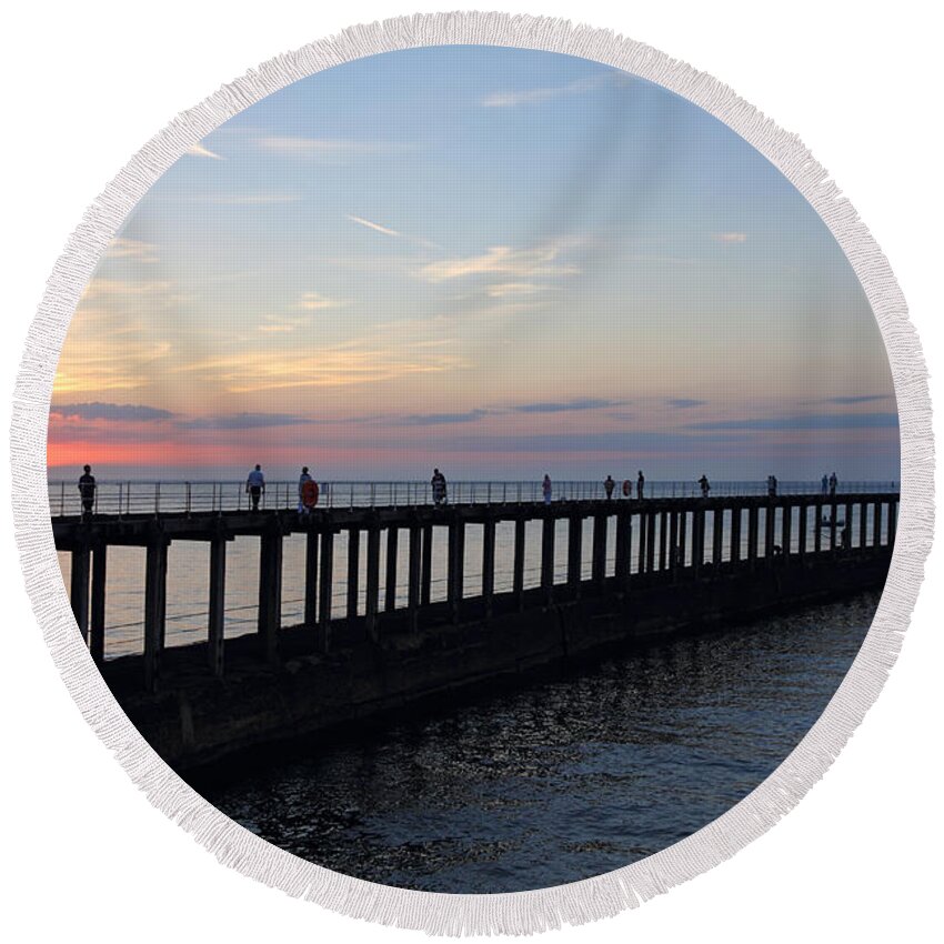 Sunset Over Whitby Pier Yorkshire England Uk Round Beach Towel featuring the photograph Sunset over Whitby Pier Yorkshire England UK by Julia Gavin