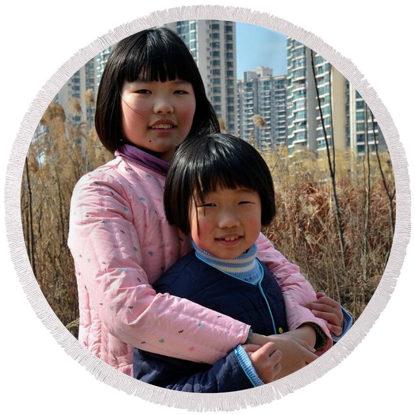 Girls Round Beach Towel featuring the photograph Two Chinese teen sisters hug and embrace Shanghai China by Imran Ahmed