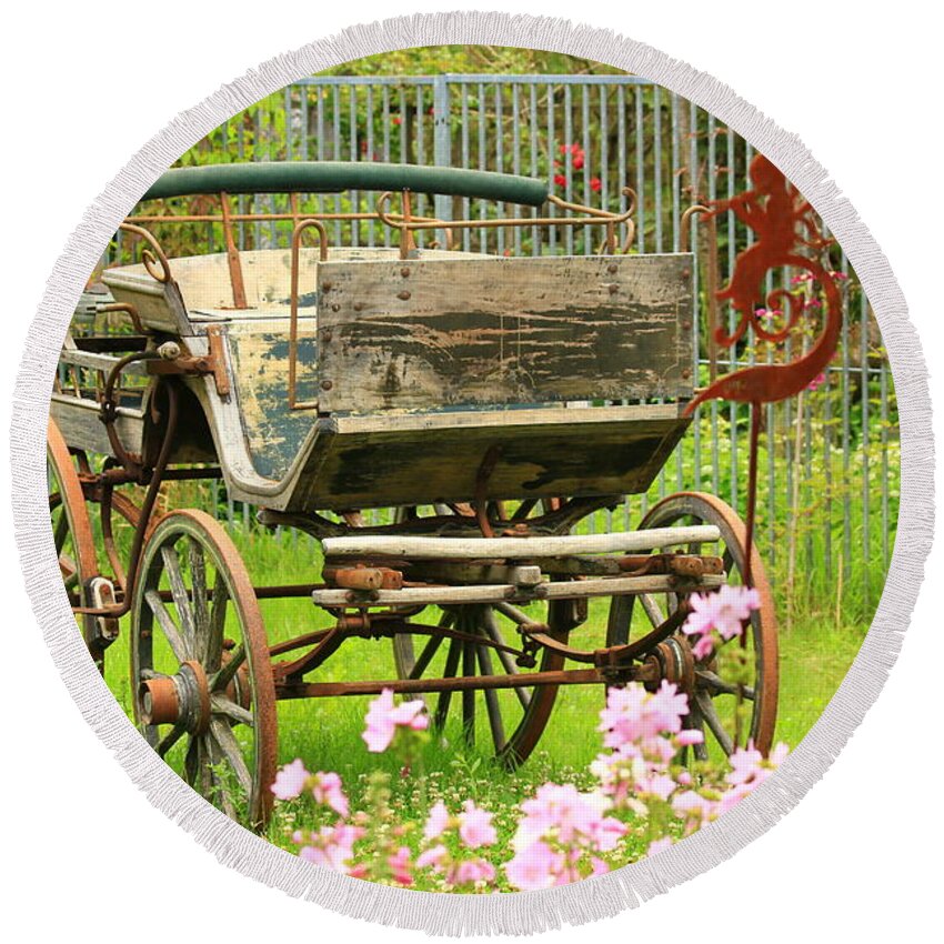 Aged Round Beach Towel featuring the photograph Vintage horse carriage in a flower bed by Amanda Mohler