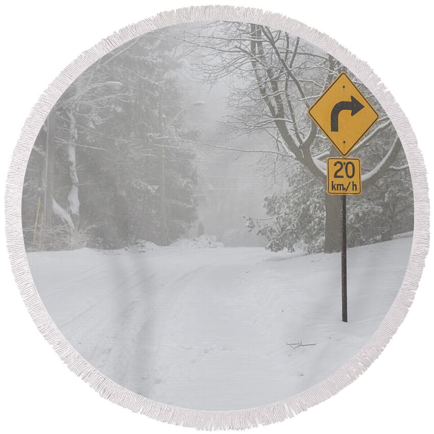 Winter Round Beach Towel featuring the photograph Winter road with yellow sign by Elena Elisseeva