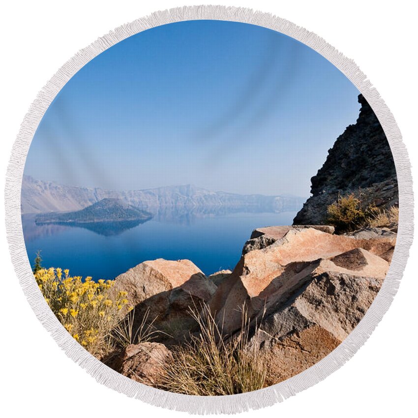 Awe Round Beach Towel featuring the photograph Yellow Wildflowers and Rocks Above Crater Lake by Jeff Goulden