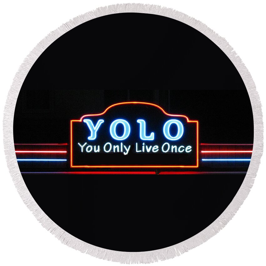 Yolo Round Beach Towel featuring the photograph YOLO You Only Live Once neon light design by Tom Conway