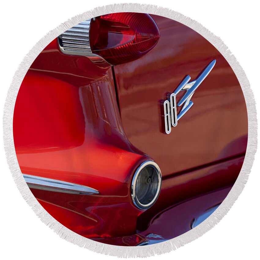 1956 Oldsmobile 88 Round Beach Towel featuring the photograph 1956 Oldsmobile 88 Taillight Emblem by Jill Reger