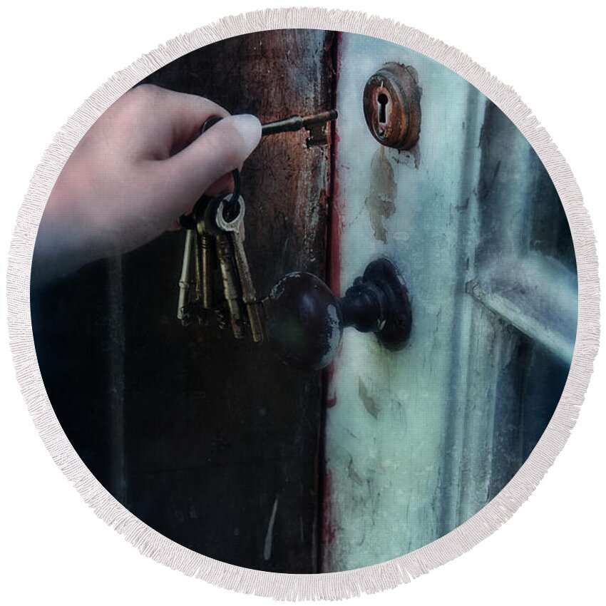 Hand Round Beach Towel featuring the photograph Hand Putting Vintage Key Into Lock by Jill Battaglia