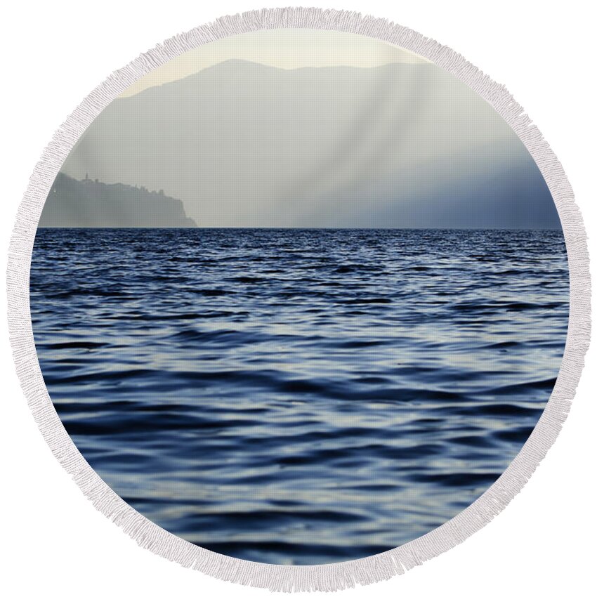 Lake Round Beach Towel featuring the photograph Misty alpine lake with mountains by Mats Silvan
