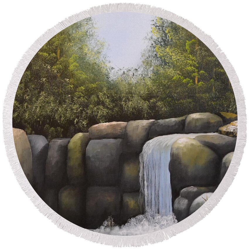 A Painting Of A Waterfalls In A Forest With Large Boulders. There Is A Blue Cloudless Sky And The Forest Trees Have Very Dense Green Leaves. The Large Boulders Are Different Colors And The Small Lake Water Is Dark In Color. Round Beach Towel featuring the painting Rocky Falls by Martin Schmidt