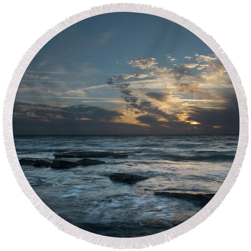 Sunset Over Sea Round Beach Towel featuring the photograph Sunset on a rocky beach by Michalakis Ppalis