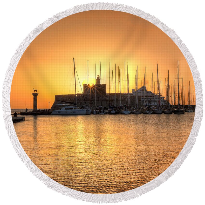 Aegean Round Beach Towel featuring the photograph The sunrise at the old port of Rhodes - Greece #1 by Constantinos Iliopoulos