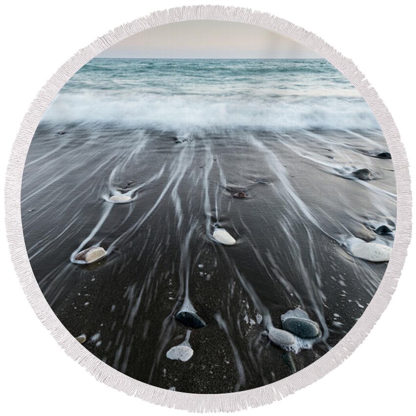 Seascape Round Beach Towel featuring the photograph Pebbles in the beach and flowing sea water by Michalakis Ppalis
