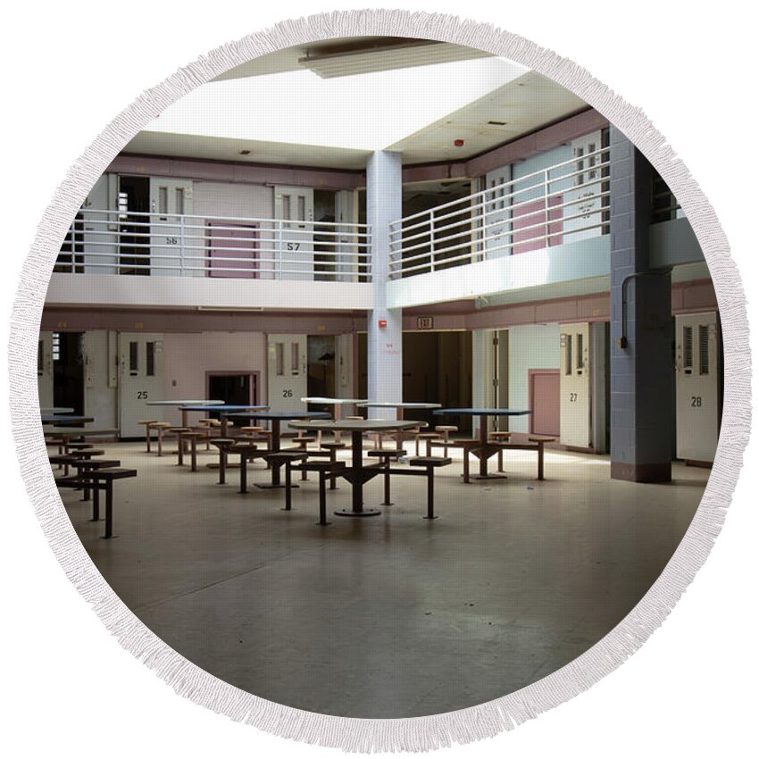 America Round Beach Towel featuring the photograph Abandoned jail common room in cell block by Karen Foley