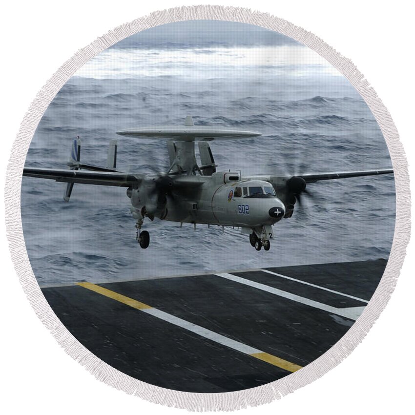 Aircraft Carrier Round Beach Towel featuring the photograph An E-2c Hawkeye Lands Aboard by Stocktrek Images