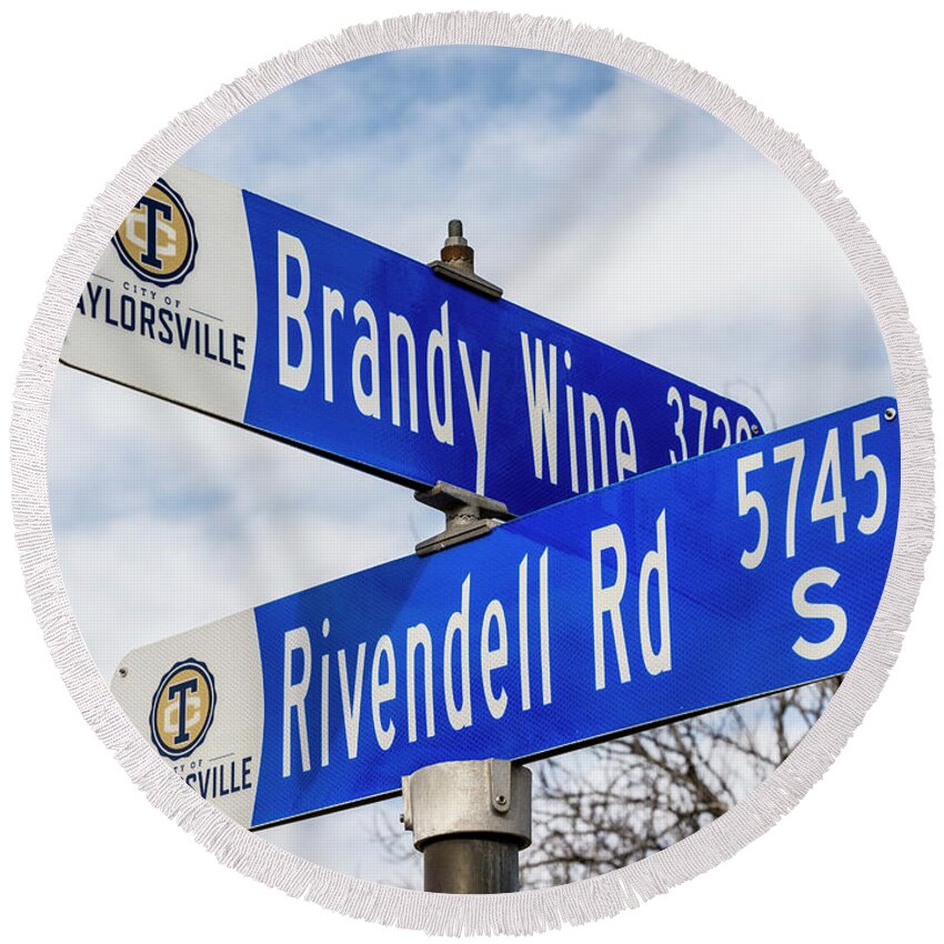 Brandywine And Rivendell - Lord Of The Rings Movie Themed Street Signs In Suburban Neighborhood. Round Beach Towel featuring the photograph Brandywine And Rivendell Street Signs by Gary Whitton