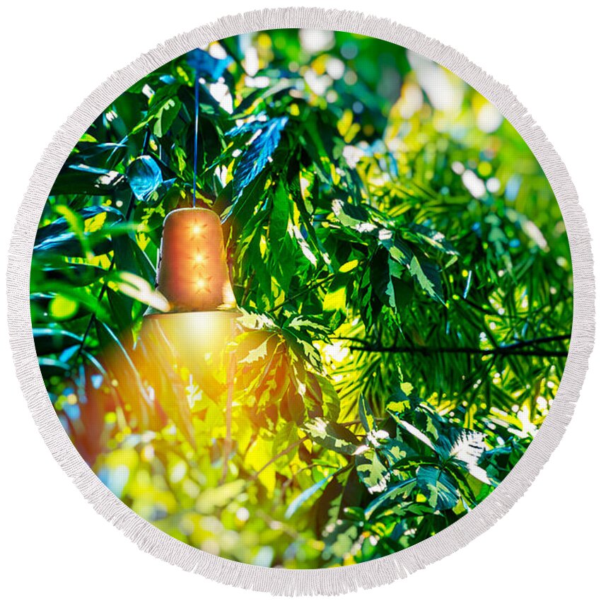 Background Round Beach Towel featuring the photograph Bright lantern among green foliage by Anna Om
