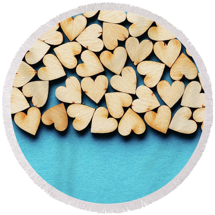 Love Round Beach Towel featuring the photograph Bunch of hearts on blue background. by Michal Bednarek