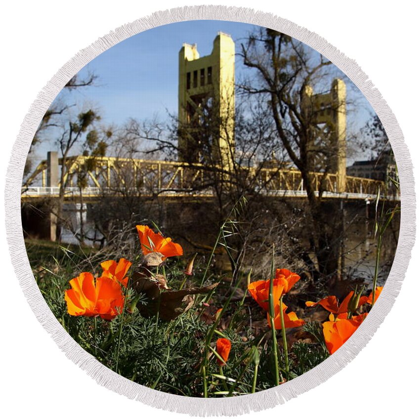 Landscape Round Beach Towel featuring the photograph California Poppies With The Slightly Photographically Blurred Sacramento Tower Bridge In The Back by Wingsdomain Art and Photography