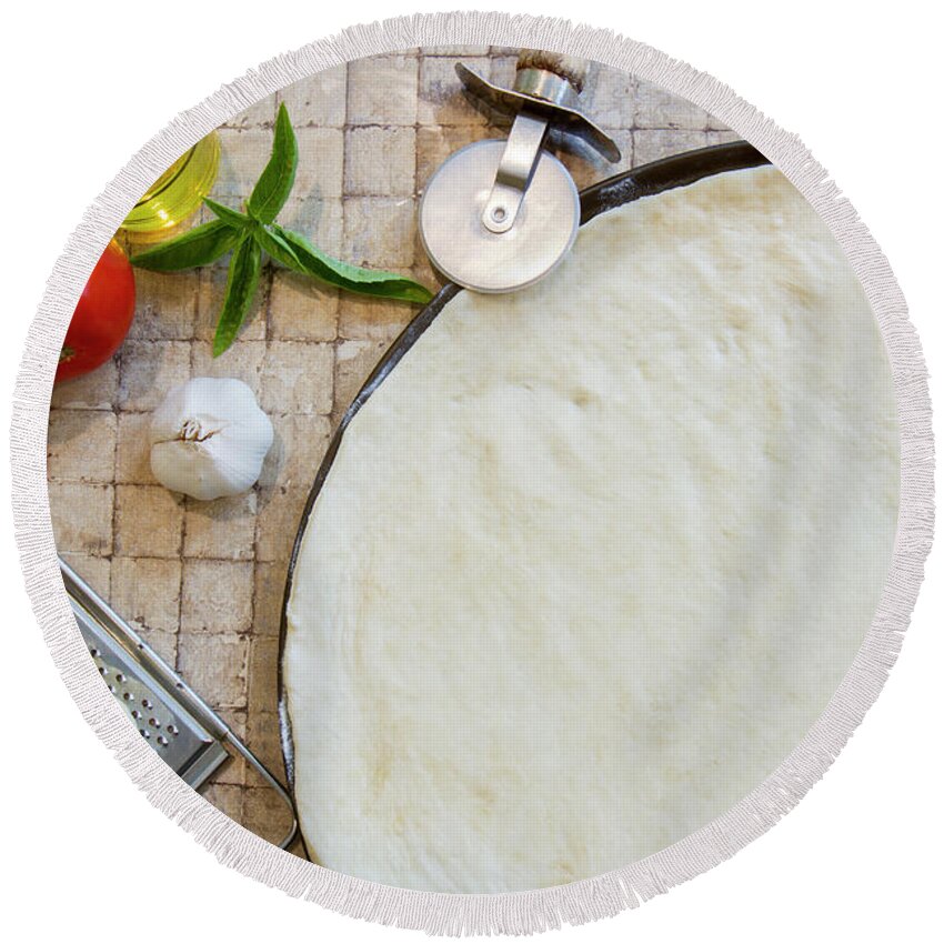 Basil Round Beach Towel featuring the photograph Cheese margarita pizza ingredients and raw crust with cutter by Karen Foley