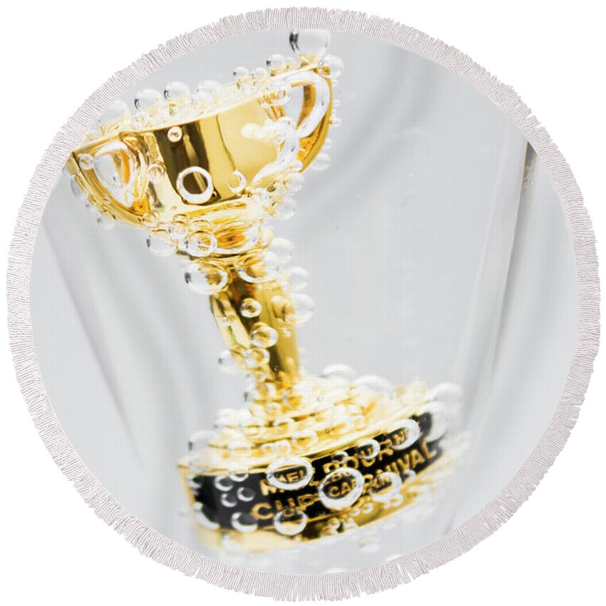 Horse Round Beach Towel featuring the photograph Closeup of small trophy in champagne flute. Gold colored award i by Jorgo Photography