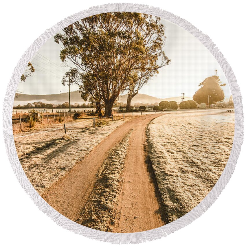 Dirt Round Beach Towel featuring the photograph Dirt frosted country road in winter by Jorgo Photography