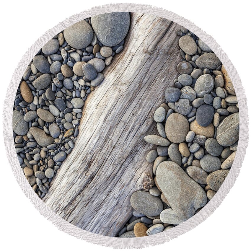 Driftwood Round Beach Towel featuring the photograph Driftwood on Rock Covered Beach by Bryan Mullennix
