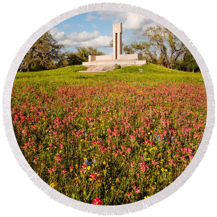 James Round Beach Towel featuring the photograph Fannin Monument and Memorial with Wildflowers in Goliad - Coastal Bend South Texas by Silvio Ligutti