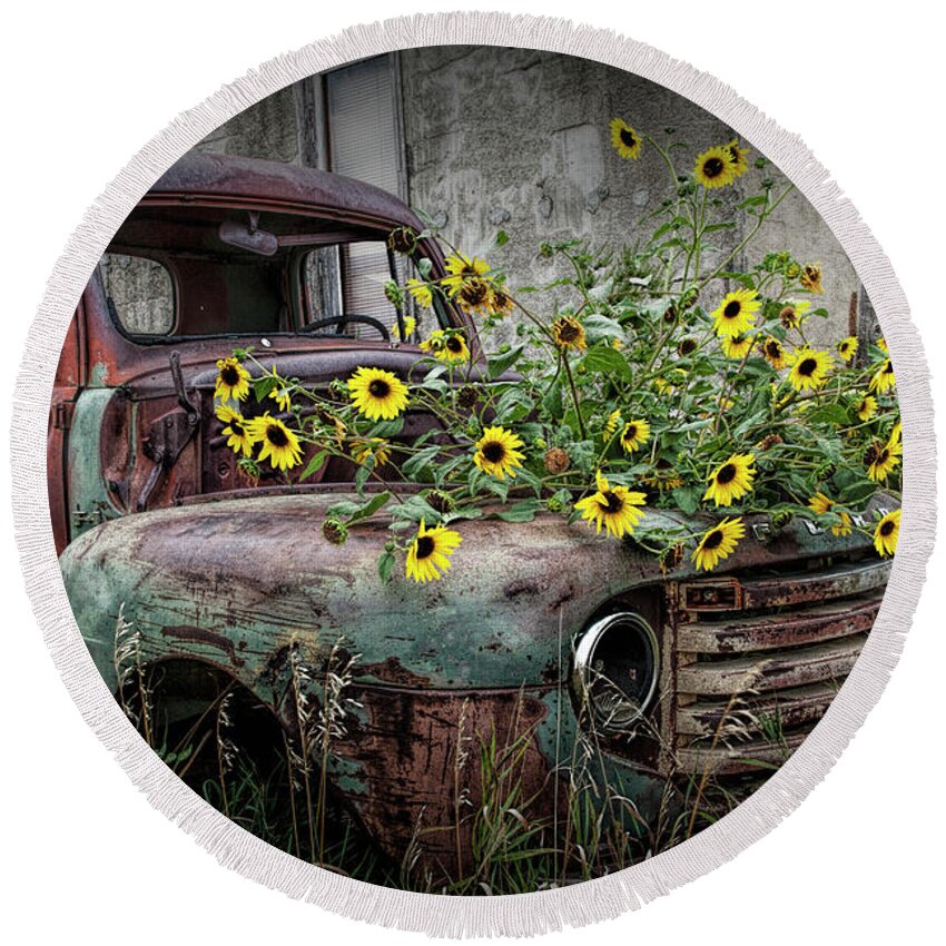 Art Round Beach Towel featuring the photograph Ford Truck with Yellow Flowers abandoned in the Ghost Town by Okaton South Dakota by Randall Nyhof