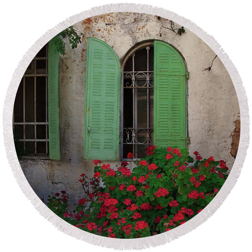 City Round Beach Towel featuring the photograph Green windows and red geranium flowers by Yair Karelic