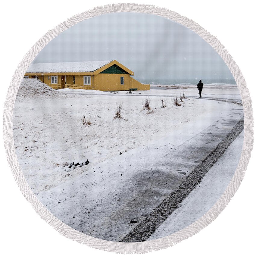 Iceland Round Beach Towel featuring the photograph Man walking in snow Iceland by Michalakis Ppalis
