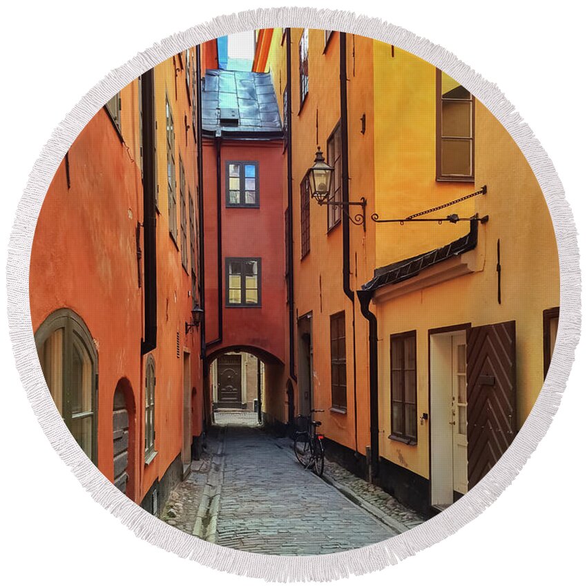 Stockholm Round Beach Towel featuring the photograph Narrow street in the old center of Stockholm by GoodMood Art