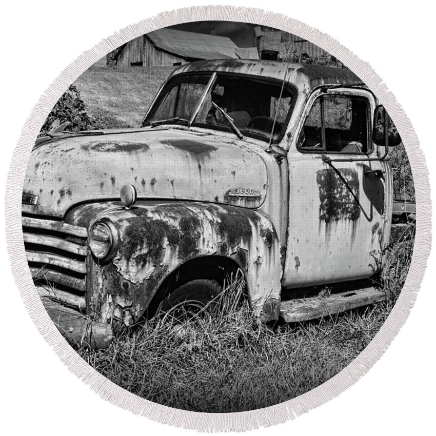 Paul Ward Round Beach Towel featuring the photograph Old Rusty Chevy in black and white by Paul Ward