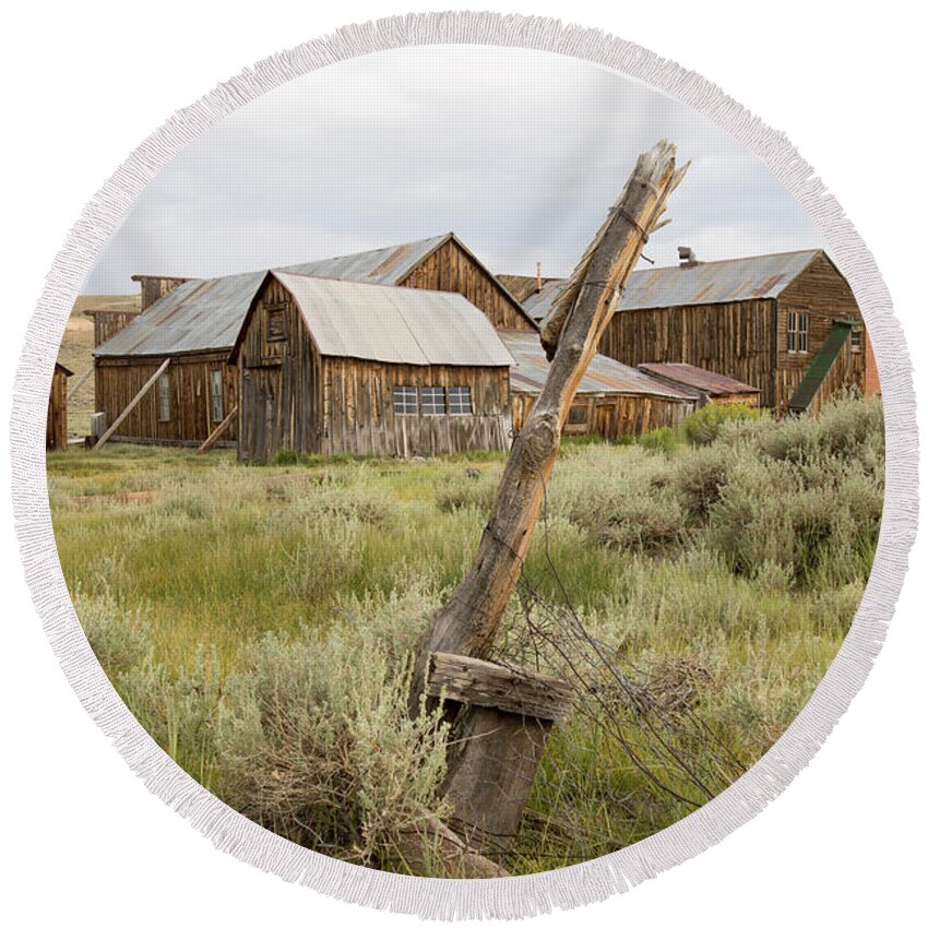Abandoned Round Beach Towel featuring the photograph Rustic wooden structures in Bodie, California by Karen Foley