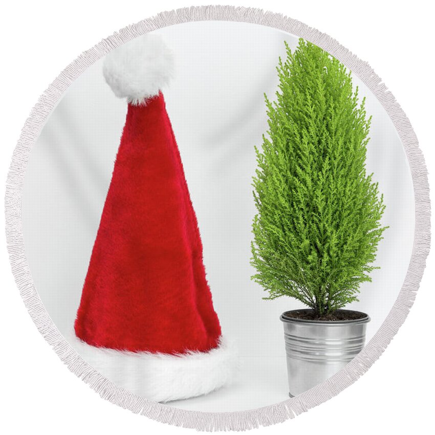 Santa Hat Round Beach Towel featuring the photograph Santa hat and little Christmas tree by GoodMood Art