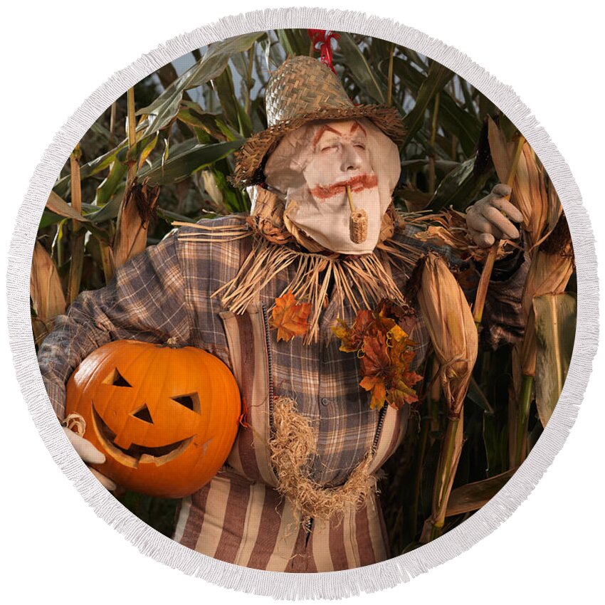 Scarecrow Round Beach Towel featuring the photograph Scarecrow with a Carved Pumpkin in a Corn Field by Maxim Images Exquisite Prints